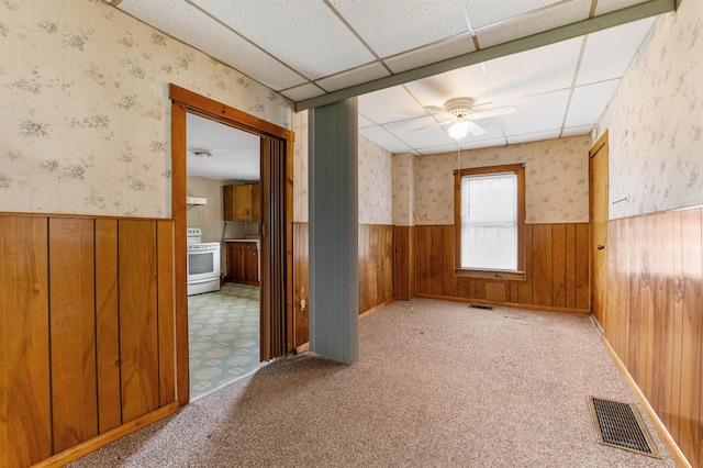 25 Eames St, Northumberland, NH 03582 - empty room with a wainscoted wall, wallpapered walls, a ceiling fan, and wood walls