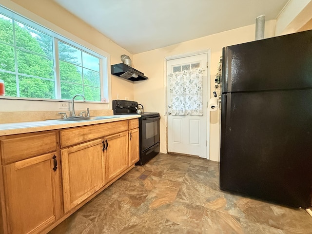 19 Gambier St, Claremont, NH 03743 - kitchen featuring black appliances, a sink, ventilation hood, light countertops, and stone finish flooring