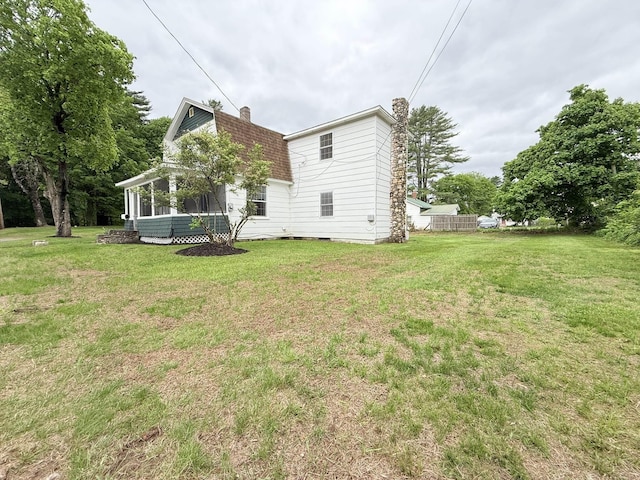 19 Gambier St, Claremont, NH 03743 - back of house featuring a chimney, a lawn, and a sunroom