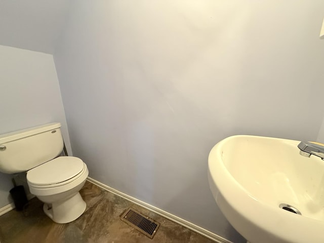 19 Gambier St, Claremont, NH 03743 - half bathroom featuring a sink, toilet, and baseboards