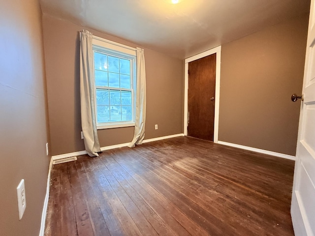 19 Gambier St, Claremont, NH 03743 - spare room featuring dark wood-style flooring and baseboards