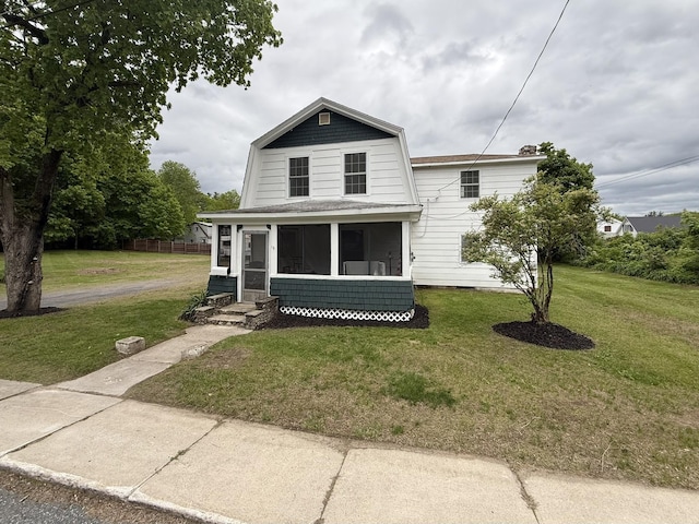 19 Gambier St, Claremont, NH 03743 - dutch colonial featuring a sunroom, a front yard, a gambrel roof, and entry steps