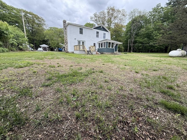 19 Gambier St, Claremont, NH 03743 - back of house with a yard and a chimney