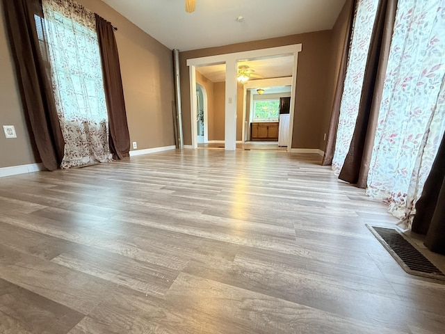 19 Gambier St, Claremont, NH 03743 - unfurnished room featuring light wood-style floors, ceiling fan, and baseboards