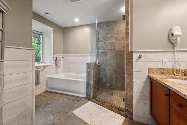 8 Wisteria Ln, Eliot, ME 03903 - full bathroom featuring a garden tub, a stall shower, vanity, stone finish floors, and recessed lighting