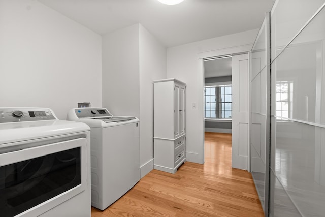 8 Wisteria Ln, Eliot, ME 03903 - laundry area with washer and dryer, light wood-type flooring, and baseboards