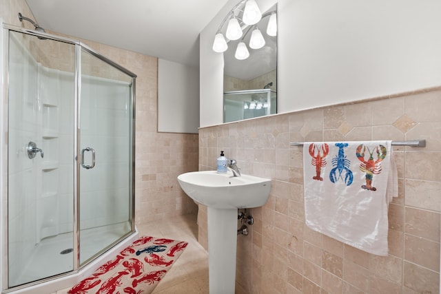 8 Wisteria Ln, Eliot, ME 03903 - full bathroom with tile walls, a shower stall, tile patterned flooring, and a sink
