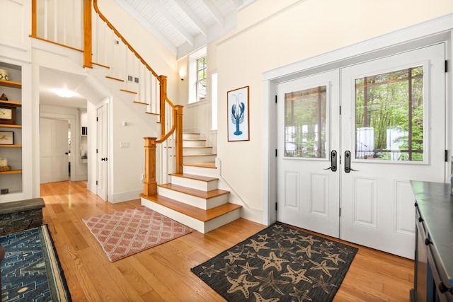 8 Wisteria Ln, Eliot, ME 03903 - foyer with stairway, light wood-type flooring, wooden ceiling with exposed beams, high vaulted ceiling, and french doors
