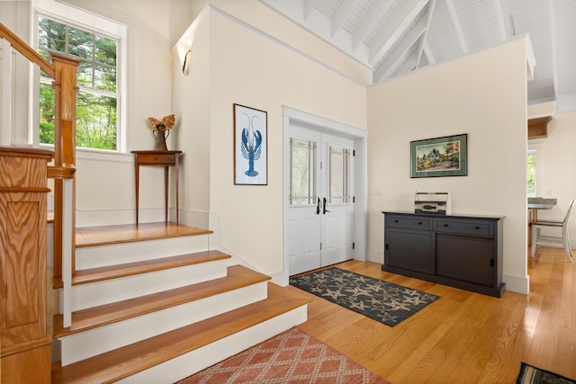 8 Wisteria Ln, Eliot, ME 03903 - entryway with stairs, light wood-style floors, wooden ceiling with exposed beams, and high vaulted ceiling