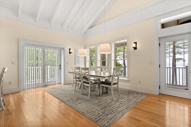 8 Wisteria Ln, Eliot, ME 03903 - dining room with light wood finished floors, plenty of natural light, high vaulted ceiling, baseboards, and beamed ceiling