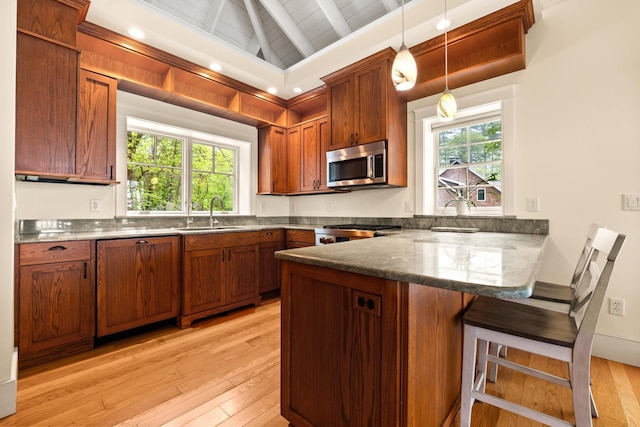 8 Wisteria Ln, Eliot, ME 03903 - kitchen featuring stainless steel microwave, a sink, a peninsula, light wood finished floors, and wood ceiling