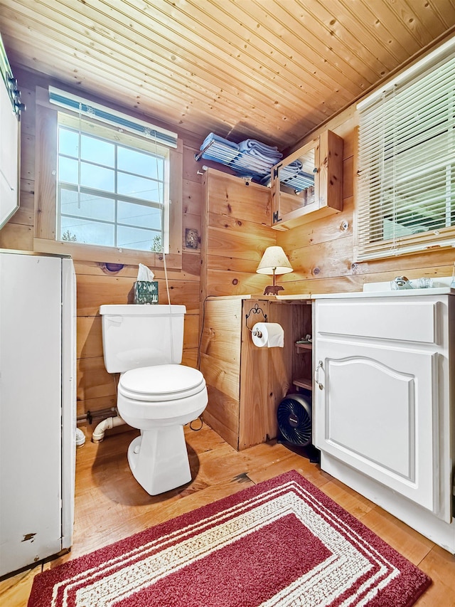 718 Reed Rd, Colebrook, NH 03576 - half bath featuring wood finished floors, toilet, wood ceiling, and wood walls