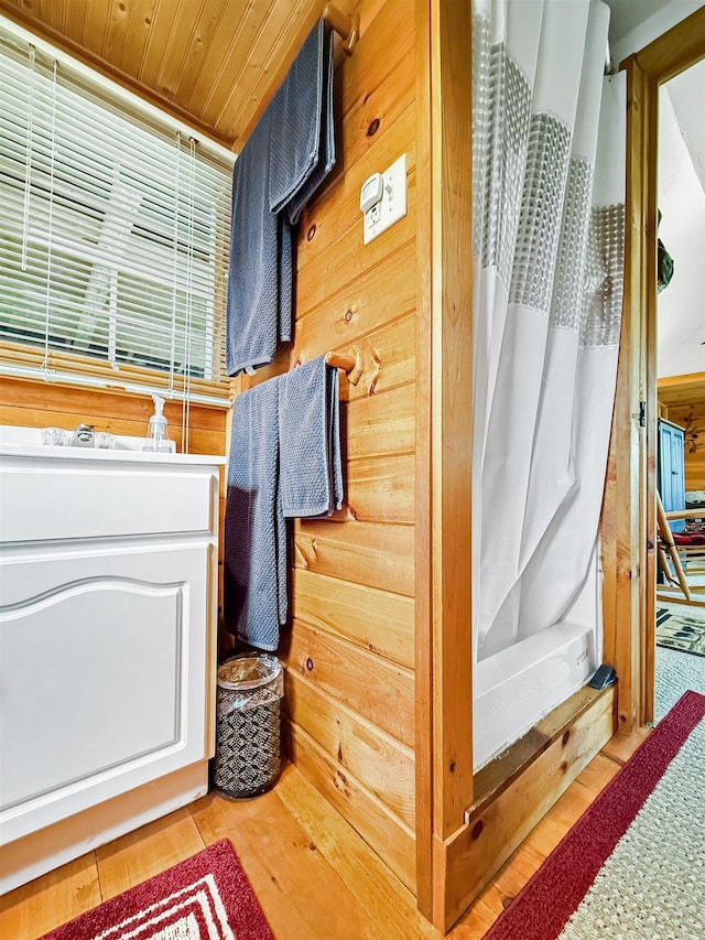 718 Reed Rd, Colebrook, NH 03576 - bathroom featuring wooden ceiling, wood finished floors, wooden walls, and a shower with shower curtain