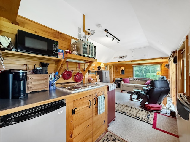 718 Reed Rd, Colebrook, NH 03576 - kitchen featuring black microwave, lofted ceiling, stainless steel microwave, stovetop, and wooden walls