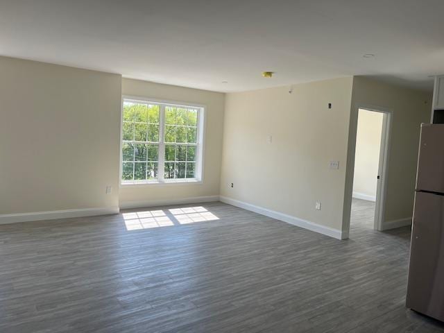 725 Central Ave Unit 101, Dover, NH 03820 - unfurnished room with baseboards and dark wood-style flooring
