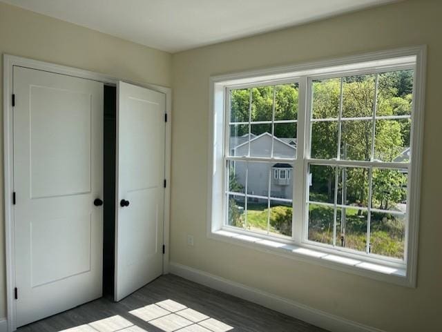 725 Central Ave Unit 101, Dover, NH 03820 - unfurnished bedroom featuring a closet and wood finished floors