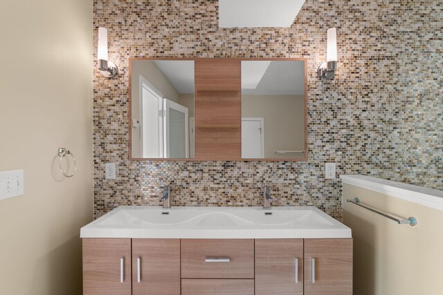 430 Clearwater Rd, Shelburne, VT 05482 - full bathroom featuring double vanity and decorative backsplash