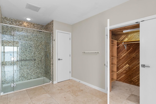 430 Clearwater Rd, Shelburne, VT 05482 - bathroom featuring a shower stall, a spacious closet, baseboards, and tile patterned flooring