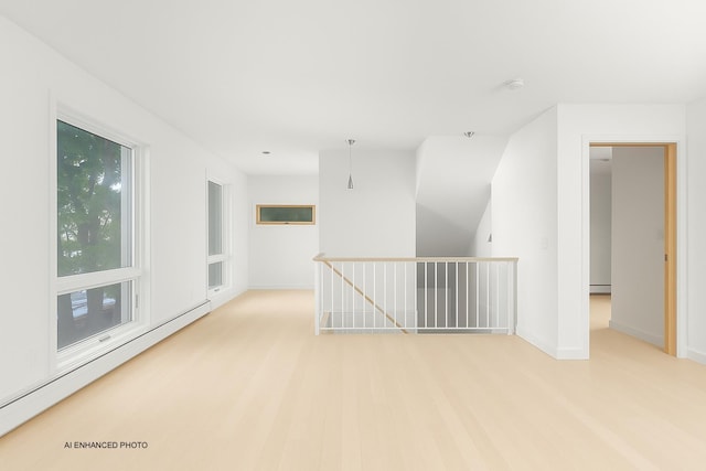 430 Clearwater Rd, Shelburne, VT 05482 - unfurnished room with a baseboard heating unit, baseboards, and light wood-style flooring