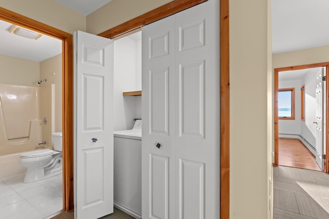 430 Clearwater Rd, Shelburne, VT 05482 - full bathroom with washer / clothes dryer, toilet, shower / bath combination, and a closet