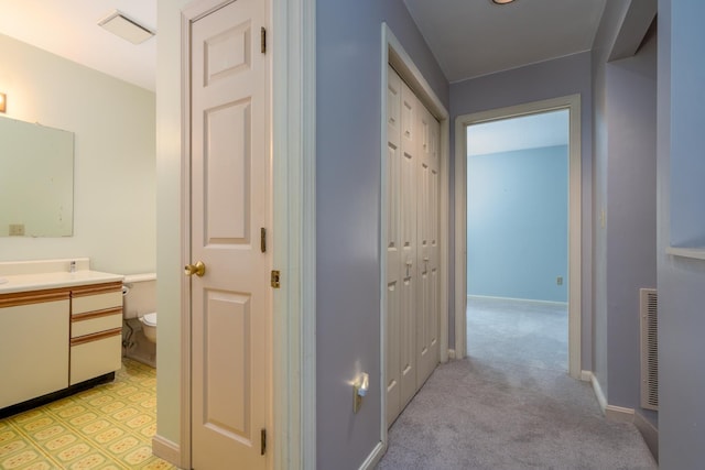 1 Village Falls Way Unit 1, Merrimack, NH 03054 - corridor featuring light colored carpet and baseboards