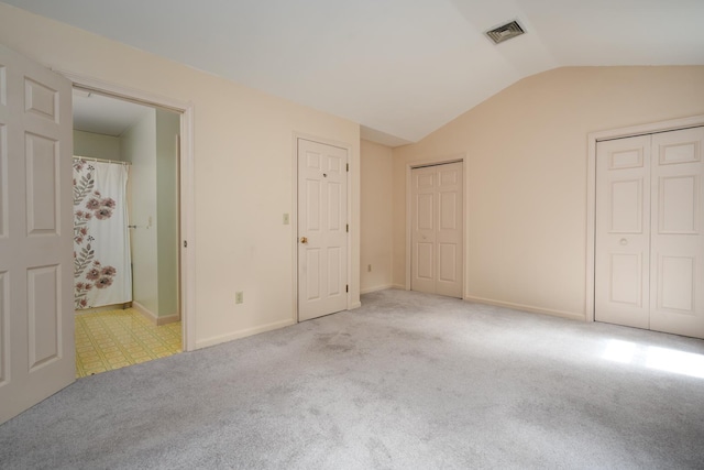 1 Village Falls Way Unit 1, Merrimack, NH 03054 - unfurnished bedroom featuring lofted ceiling, two closets, carpet floors, and baseboards