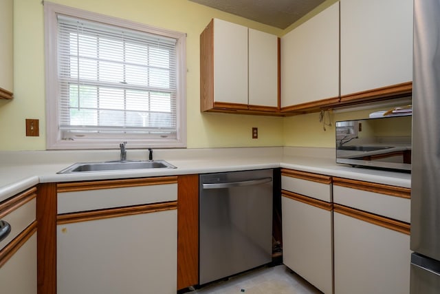 1 Village Falls Way Unit 1, Merrimack, NH 03054 - kitchen with stainless steel dishwasher, a sink, light countertops, and white cabinetry