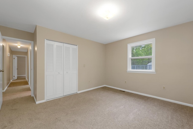 406 Lower Ridge Rd, Loudon, NH 03307 - unfurnished bedroom with light colored carpet, baseboards, and a closet