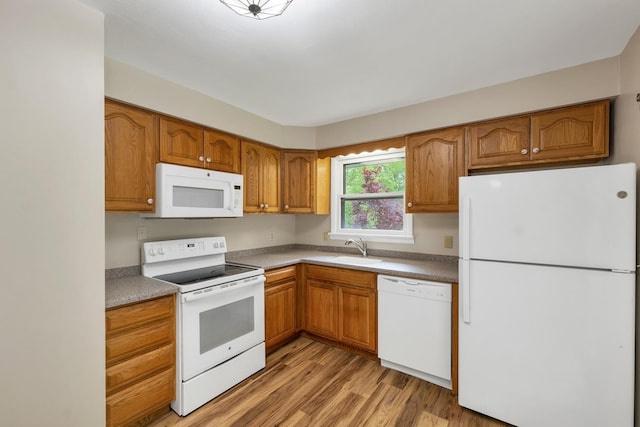 406 Lower Ridge Rd, Loudon, NH 03307 - kitchen with white appliances, light wood-style floors, brown cabinetry, and a sink