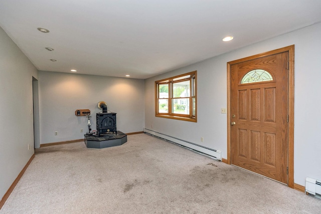 29 Laurel St, Goffstown, NH 03045 - unfurnished living room featuring baseboard heating, a wood stove, carpet, recessed lighting, and baseboards