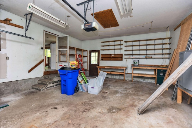 29 Laurel St, Goffstown, NH 03045 - garage featuring a garage door opener and a workshop area