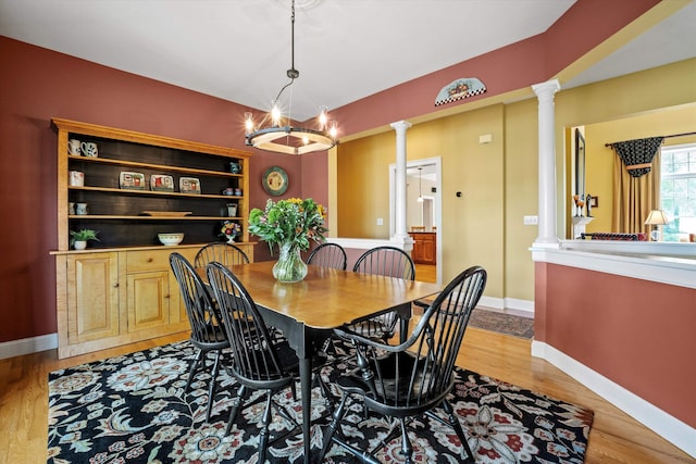 5 Smithfield Ln, Bedford, NH 03110 - dining room with decorative columns, baseboards, light wood-style floors, and a chandelier