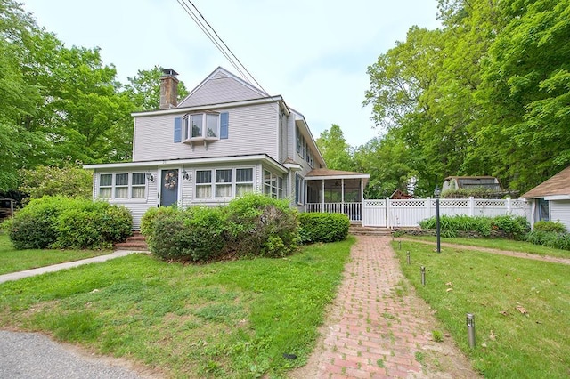 26 Main St, Sandown, NH 03873 - view of front facade with a sunroom and a chimney