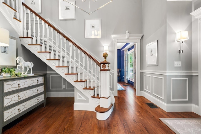 52 Hardy Rd, Bedford, NH 03110 - foyer entrance with wood finished floors, stairs, a towering ceiling, a decorative wall, and a wainscoted wall