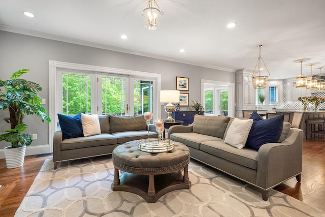 52 Hardy Rd, Bedford, NH 03110 - living room with recessed lighting, wood finished floors, baseboards, a chandelier, and crown molding