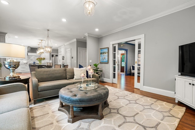52 Hardy Rd, Bedford, NH 03110 - living area with recessed lighting, wood finished floors, baseboards, ornamental molding, and a chandelier