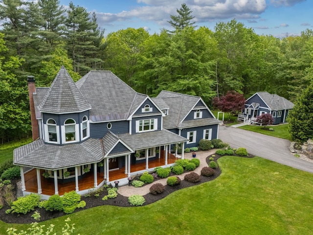 52 Hardy Rd, Bedford, NH 03110 - view of front of property featuring a porch, a chimney, a front yard, and a forest view