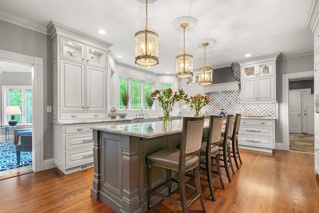 52 Hardy Rd, Bedford, NH 03110 - kitchen featuring custom exhaust hood, healthy amount of natural light, white cabinets, recessed lighting, and crown molding