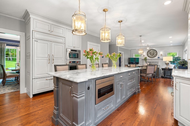 52 Hardy Rd, Bedford, NH 03110 - kitchen featuring gray cabinetry, appliances with stainless steel finishes, a chandelier, a kitchen island, and dark wood-type flooring