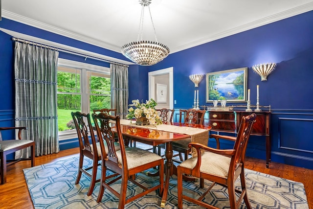 52 Hardy Rd, Bedford, NH 03110 - dining space featuring a chandelier, crown molding, a wainscoted wall, and wood finished floors