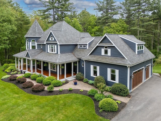 52 Hardy Rd, Bedford, NH 03110 - view of front facade featuring covered porch, a front lawn, and asphalt driveway