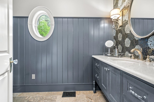 52 Hardy Rd, Bedford, NH 03110 - bathroom with vanity, stone finish flooring, and a wainscoted wall