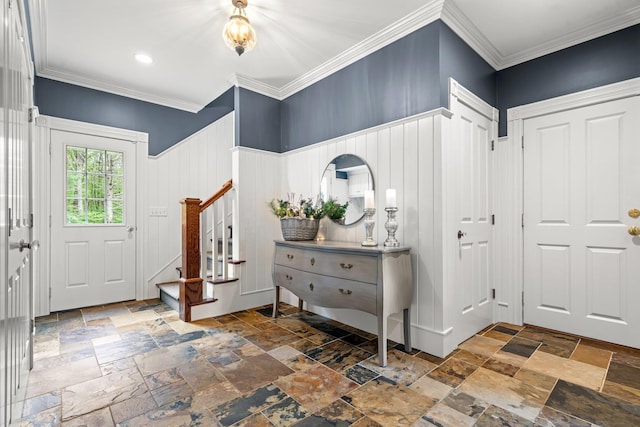 52 Hardy Rd, Bedford, NH 03110 - entrance foyer with stone tile floors, stairway, ornamental molding, and a wainscoted wall