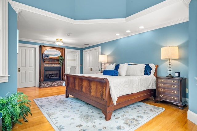 52 Hardy Rd, Bedford, NH 03110 - bedroom with a fireplace, wood finished floors, recessed lighting, crown molding, and a closet