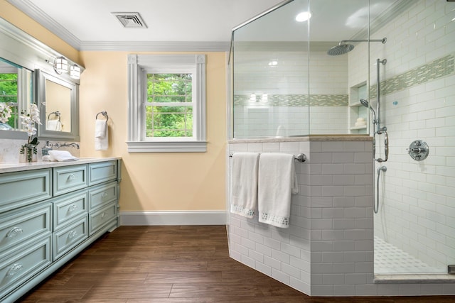 52 Hardy Rd, Bedford, NH 03110 - full bath featuring crown molding, vanity, a walk in shower, baseboards, and wood finished floors