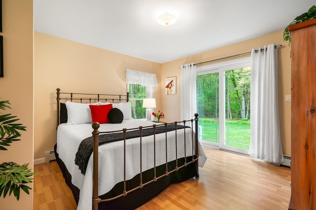 52 Hardy Rd, Bedford, NH 03110 - bedroom with access to outside, light wood-style floors, and a baseboard heating unit