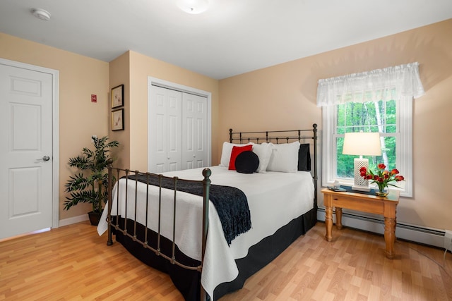 52 Hardy Rd, Bedford, NH 03110 - bedroom featuring light wood-type flooring, a closet, a baseboard radiator, and baseboards