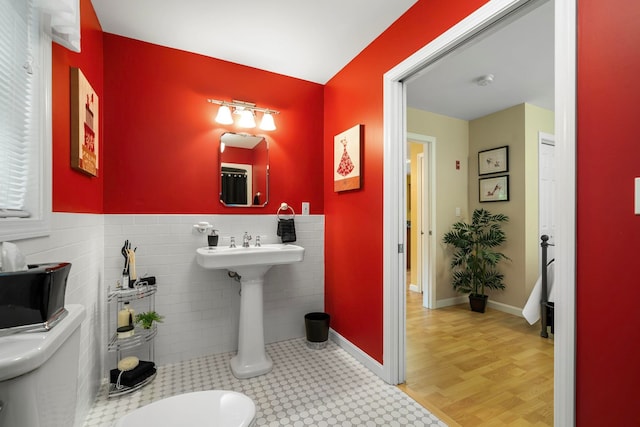 52 Hardy Rd, Bedford, NH 03110 - bathroom featuring toilet, tile walls, and a wainscoted wall