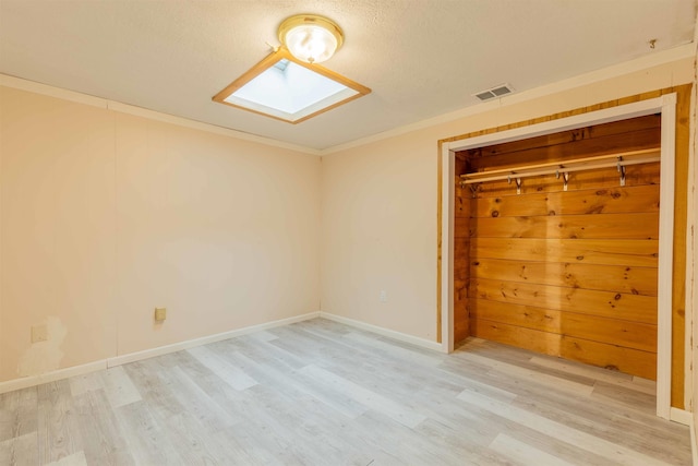 122 Flagg Rd, Rochester, NH 03839 - unfurnished bedroom with a skylight, light wood-style floors, a closet, crown molding, and baseboards