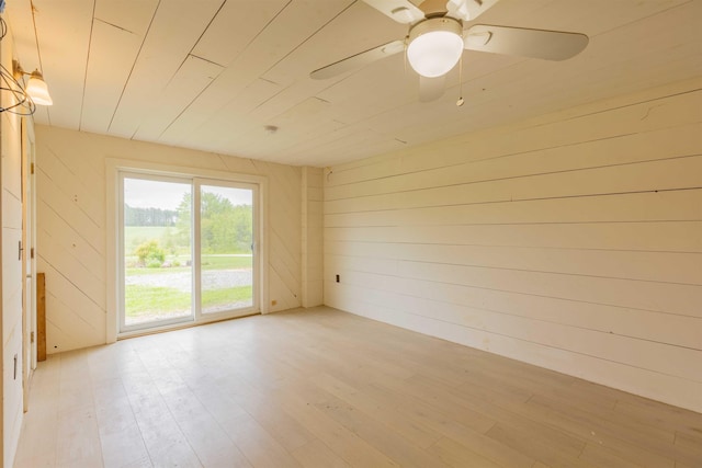 122 Flagg Rd, Rochester, NH 03839 - unfurnished room with light wood-style floors, wooden walls, and ceiling fan